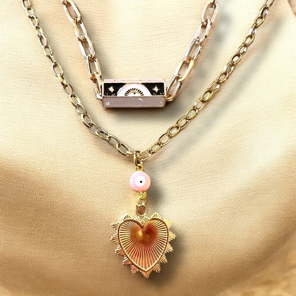 Gold toned chains with black, white, gold, and pastel pink enamel charms. - Picture 4 of 17